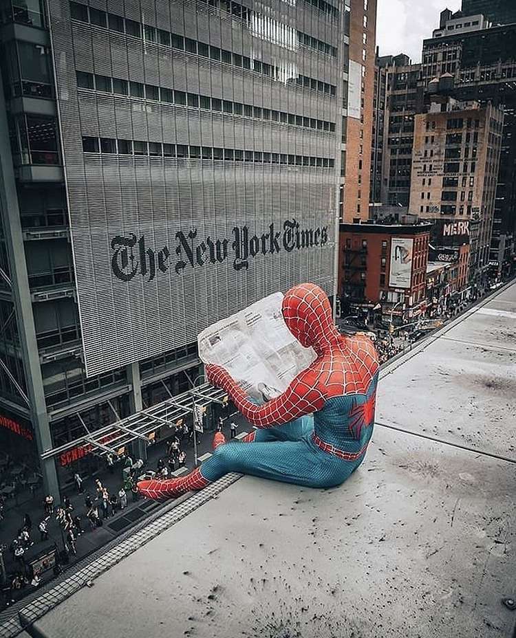 Spiderman reading yhe newspaper