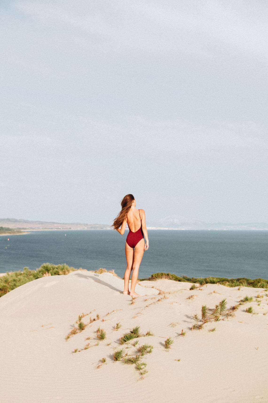 Girl standing in a dune in cadiz